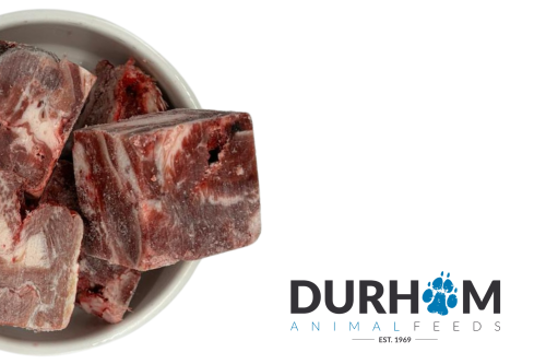 Durham Animal Feeds Beef Chunks – 1kg - raw food pictured in a bowl beside Durham branding.