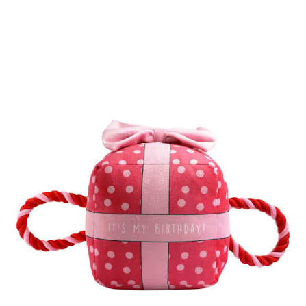 Ancol Pawty Time pink birthday present dog toy with white polka dots, a pale pink ribbon and red-and-white rope handles.